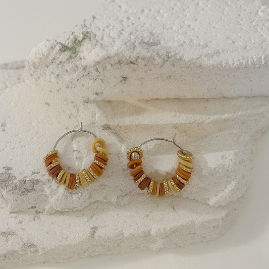 Boucle d’oreille perle plate doré